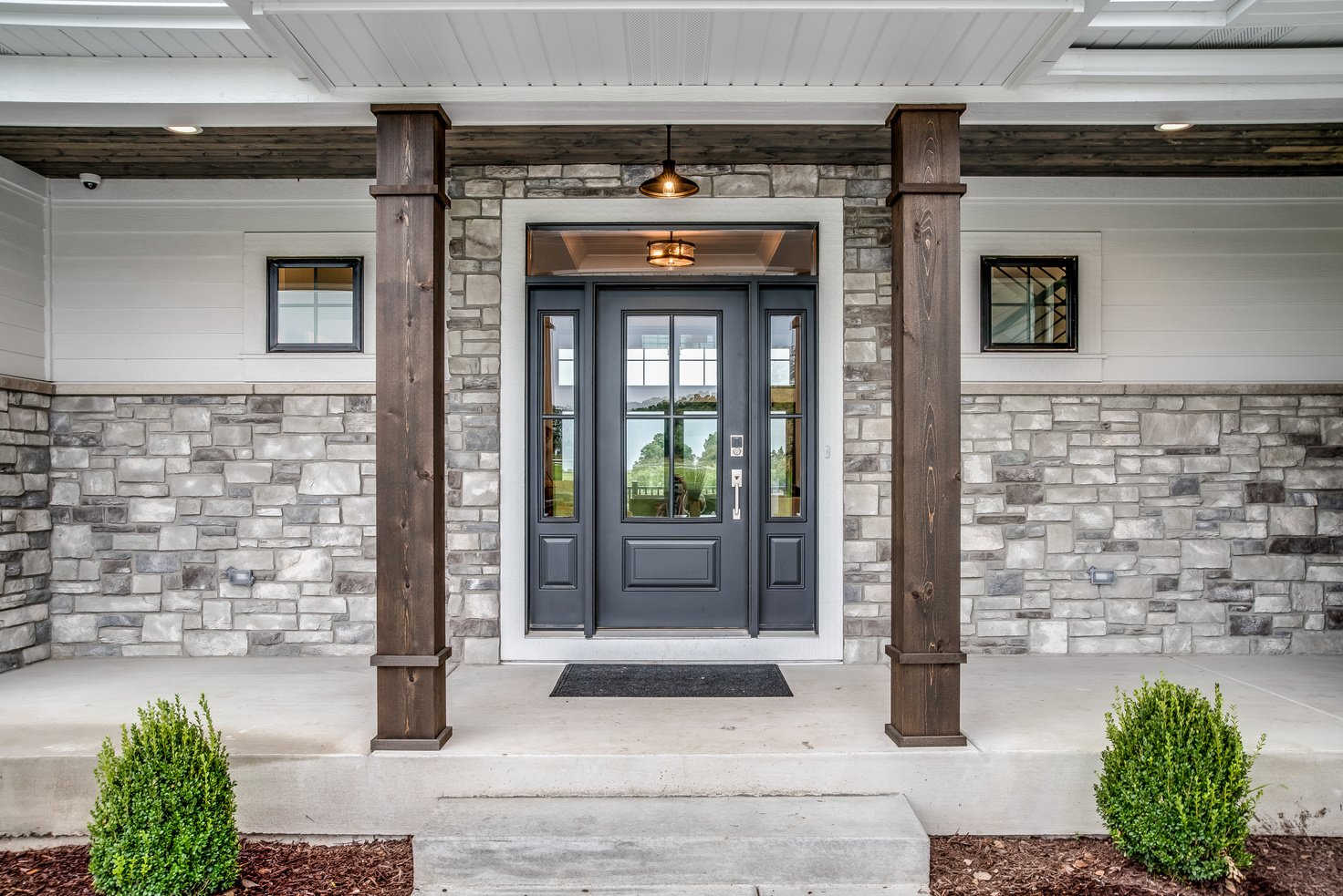 Front porch with matching brown columns